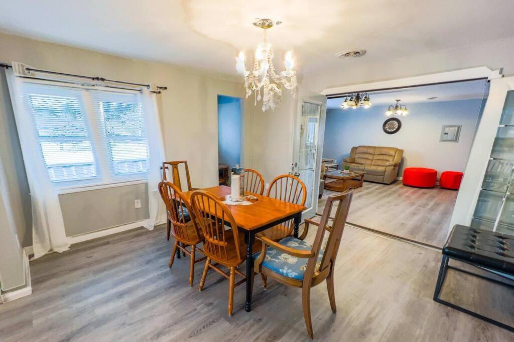 a dining room and living room with a table and chairs at Relaxing 3BR 3 Bath close to the falls in Niagara Falls