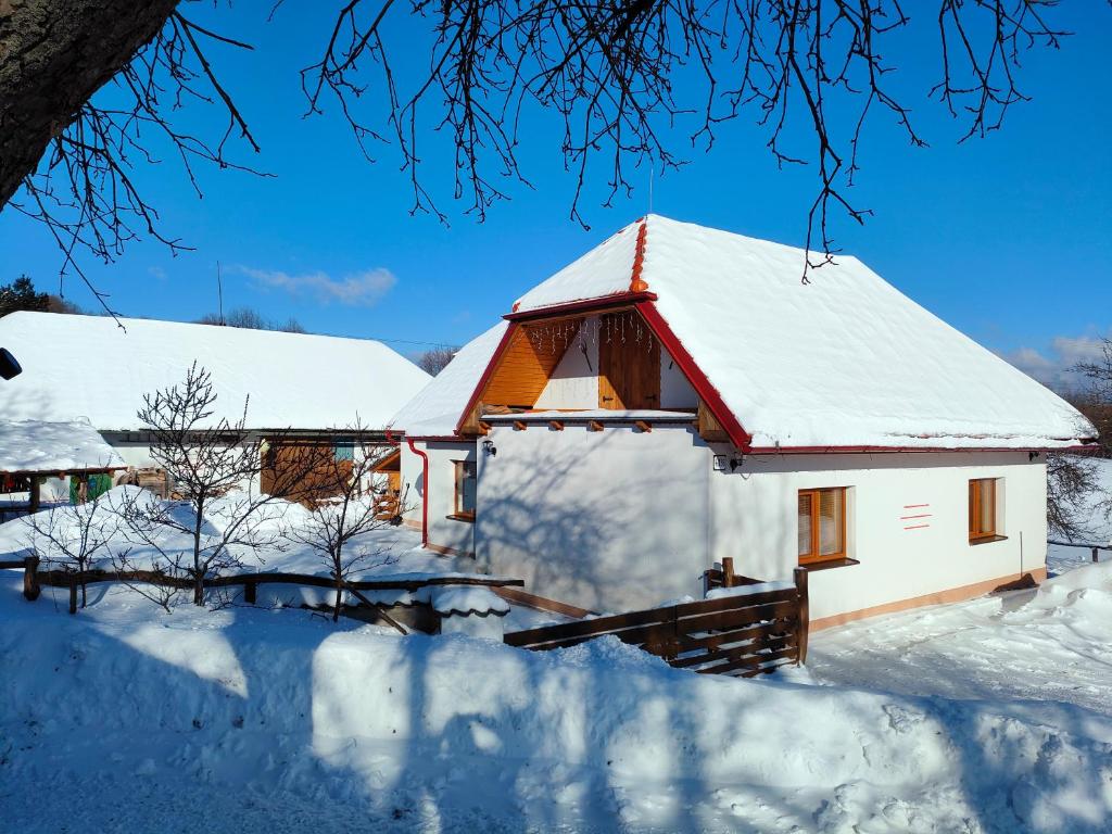 a house covered in snow at Chata Chotár Nová Baňa in Veľká Lehota