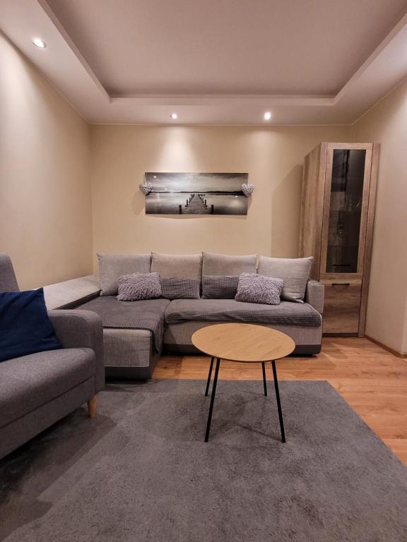 a living room with a couch and a table at Apartament pod szczęśliwą 13 in Toruń