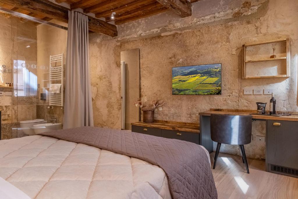 a bedroom with a bed and a desk and a sink at Truffle House Tuscany Tuber Melanosporum Vitt in Montepulciano