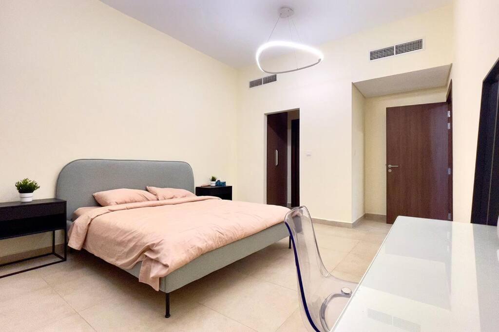 a bedroom with a bed with pink pillows on it at Azizi Luxurious 1 Bed Room apartment, Near Metro, Fully Furnished in Dubai
