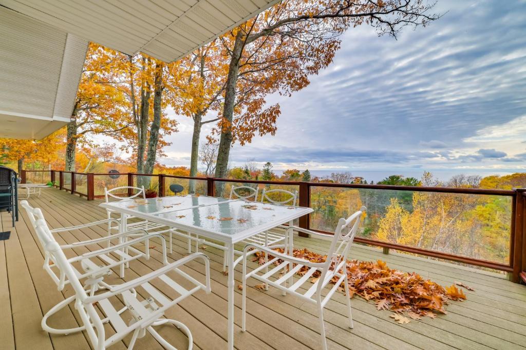 a white table and chairs on a deck at Pet-Friendly Michigan Home with Deck and Views! in Harbor Springs