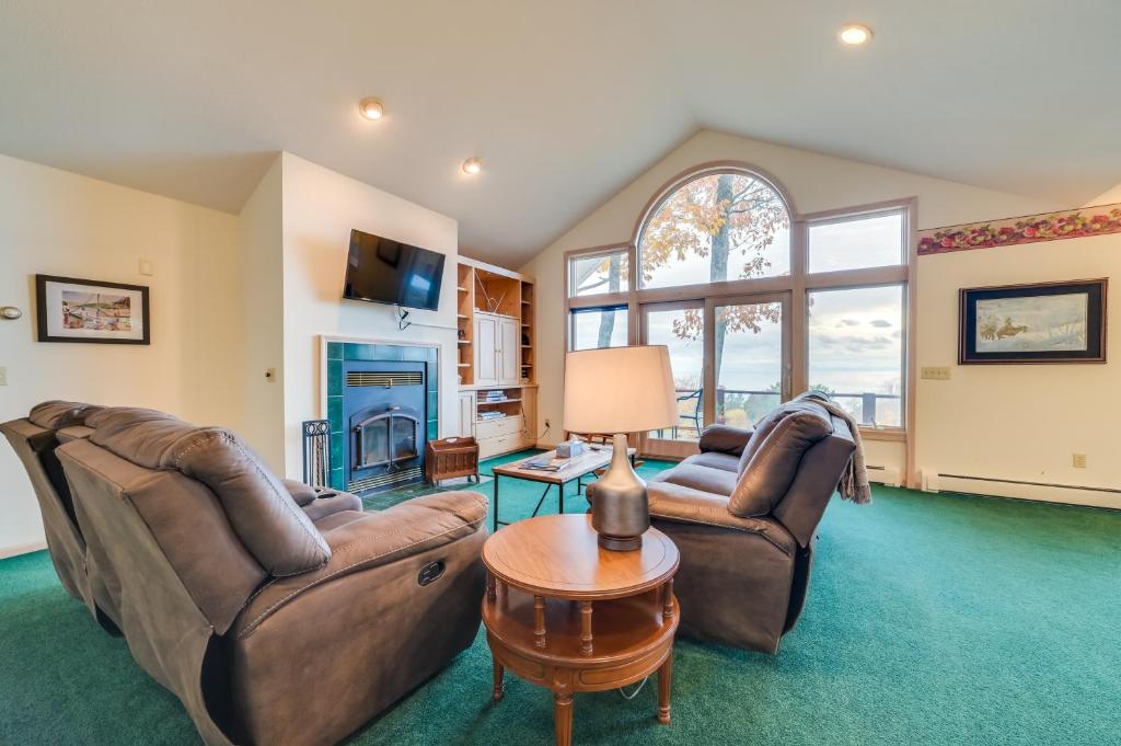 a living room with two couches and a table at 17 Mi to Skiing! Lake-View Michigan Home with Deck in Harbor Springs