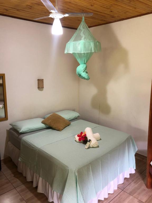 a bedroom with a bed with a light on it at Village verde in Itacaré