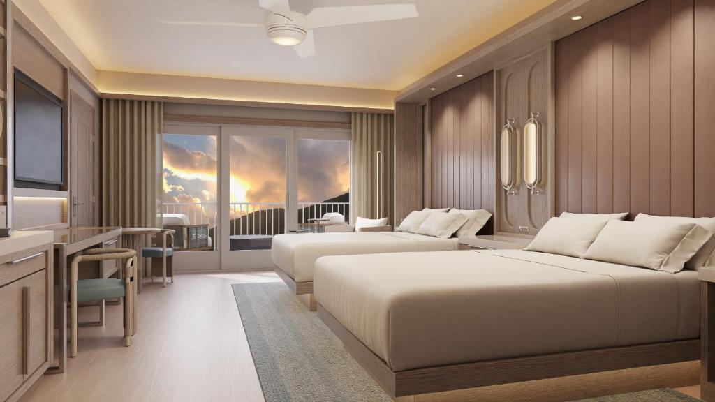a hotel room with two beds and a television at JW Marriott St Maarten Beach Resort & Spa in Dawn Beach