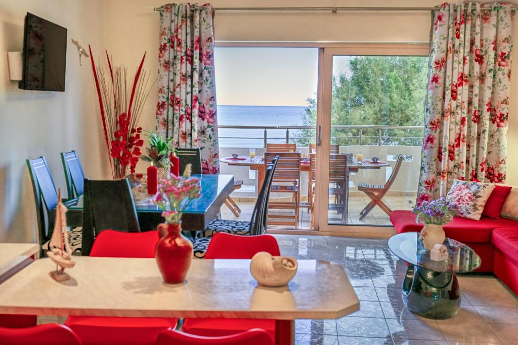 a living room with a red couch and a table at Aroma of the Sea in Kissamos