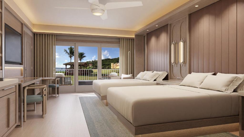 a hotel room with two beds and a television at JW Marriott St Maarten Beach Resort & Spa in Dawn Beach