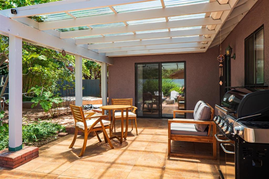 a patio with a wooden table and chairs at Spacious W Sedona 4 bedroom Contemporary House! in Sedona