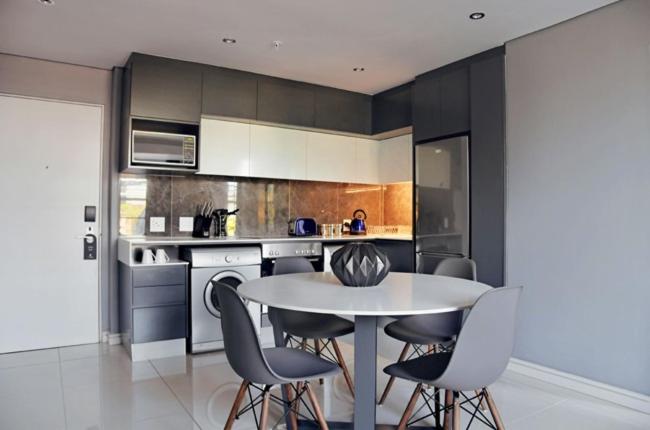 a kitchen with a table and chairs in a room at KWT property in Soweto