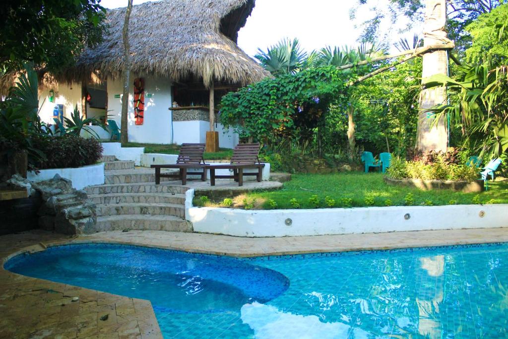 a house with a swimming pool in front of a house at Hierba Buena Eco Hostel in El Zaino