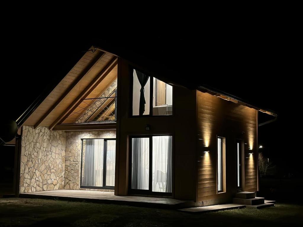 a house lit up at night with windows at The View Luxury Chalet in Jahorina