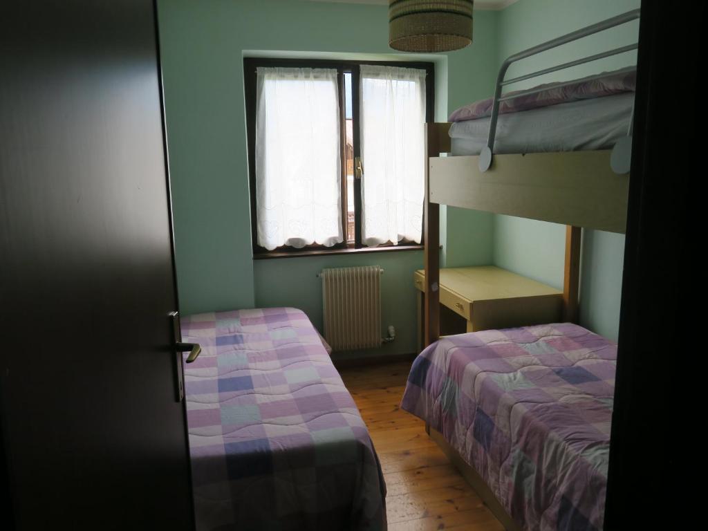 Posteľ alebo postele v izbe v ubytovaní Carè Alto