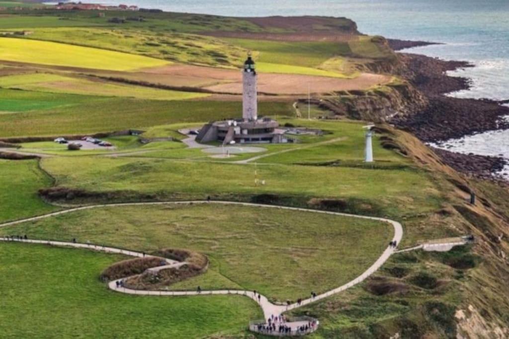an aerial view of a lighthouse on the coast at cottage du Fort Ambleteuse in Ambleteuse