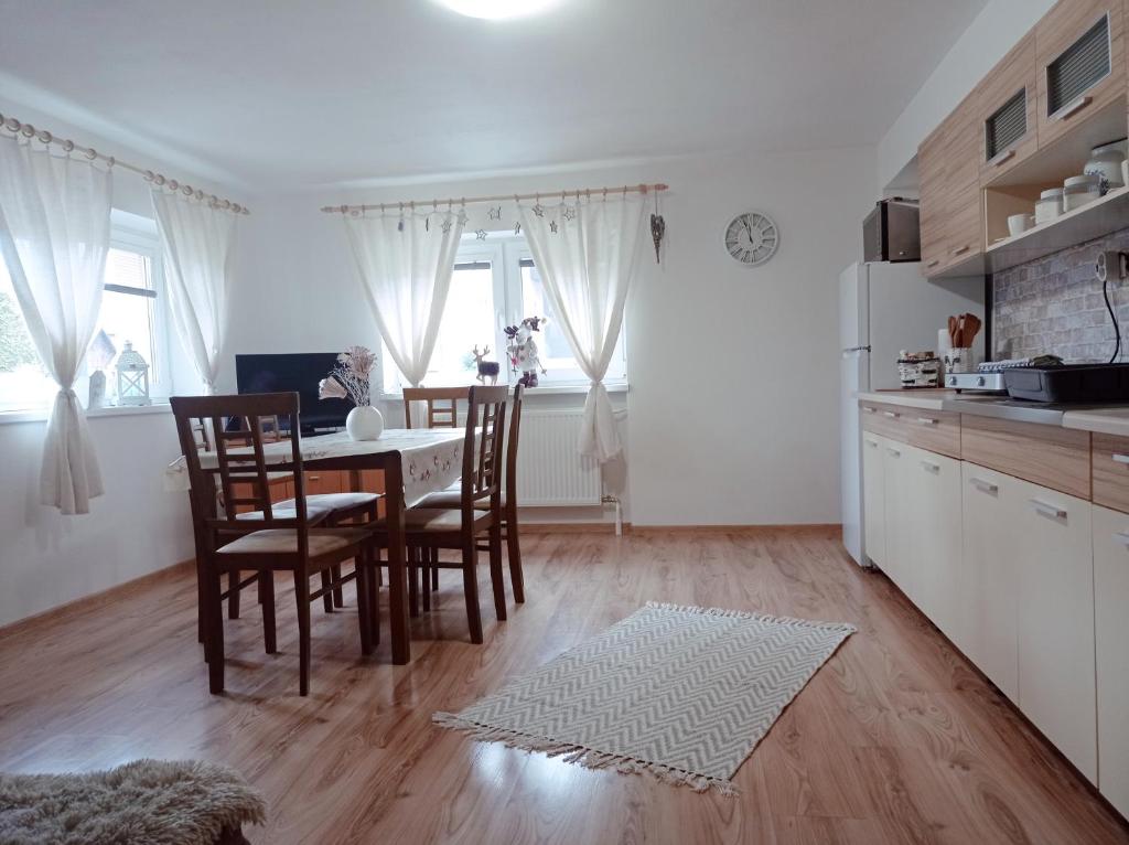 a kitchen and dining room with a table and chairs at Apartmánový dom Paula in Liptovský Mikuláš