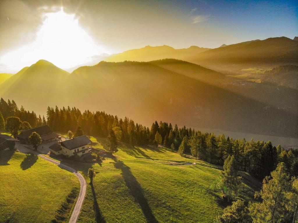 an aerial view of a house on a hill in the mountains at Kohlegghof in Schwemmberg