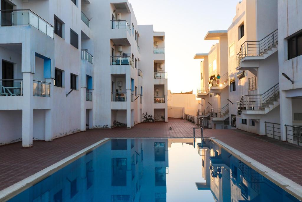 a view of an apartment complex with a swimming pool at Baya view surfside in Aourir