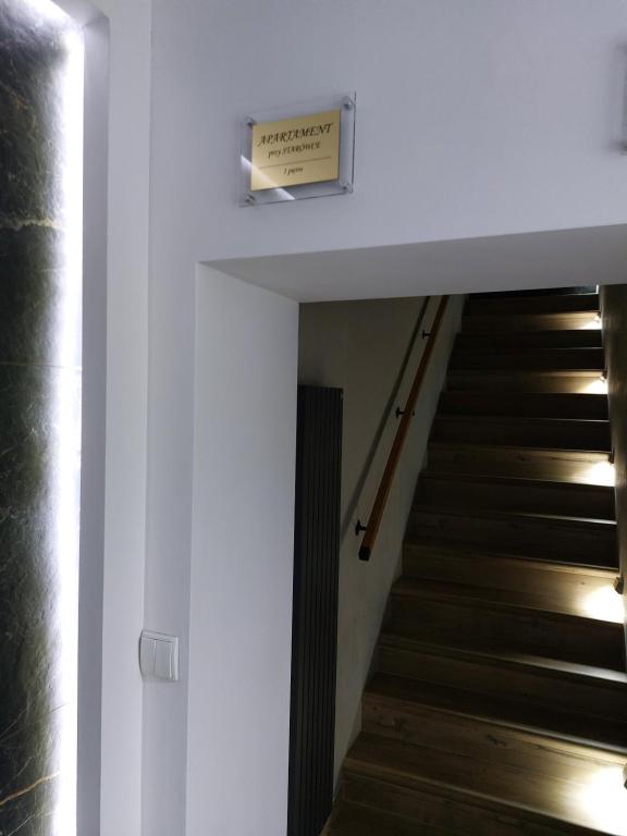 a staircase in a house with a sign on the wall at Głogów przy Starówce in Głogów