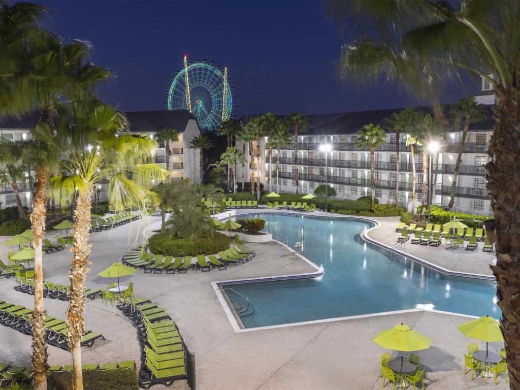 a resort with a pool and a ferris wheel at Avanti International Resort in Orlando