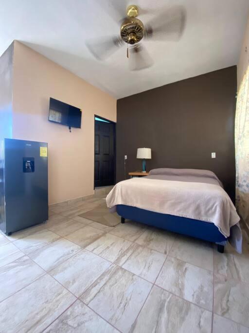 Schlafzimmer mit einem Bett und einem Deckenventilator in der Unterkunft Depa en excelente ubicación in Loreto
