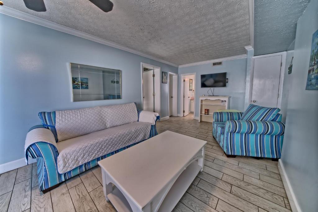 a living room with a couch and a table at Pineapple Villas in Panama City Beach