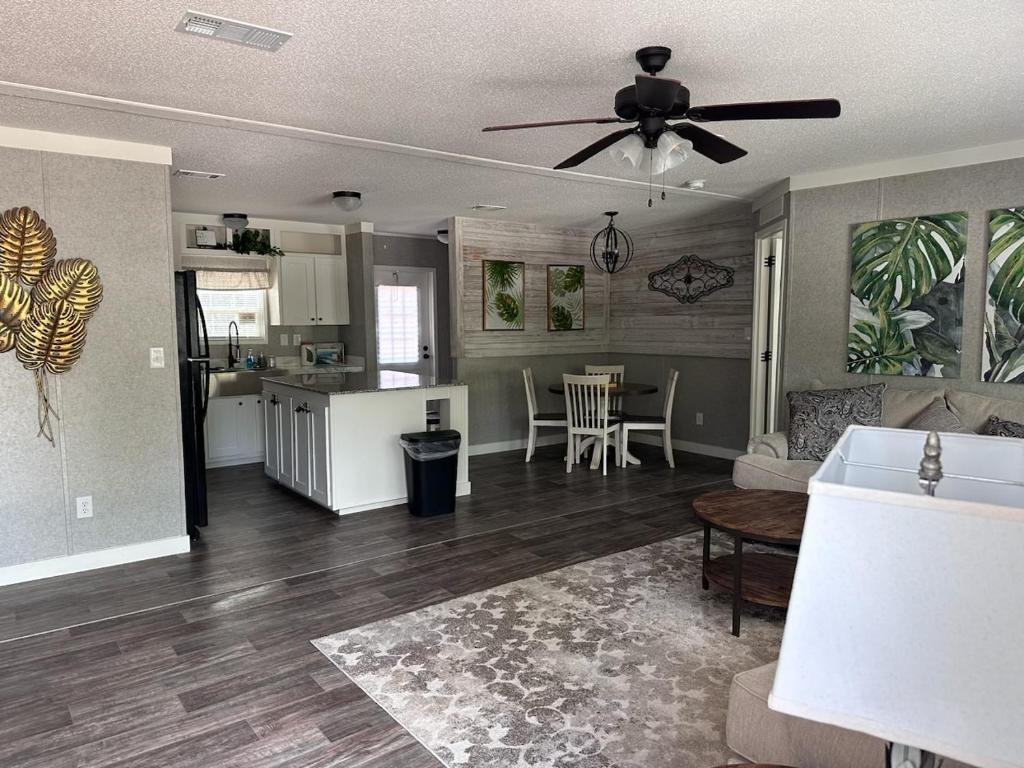 a living room and kitchen with a ceiling fan at Sweet retreat in the springs NOT waterfront property in Homosassa