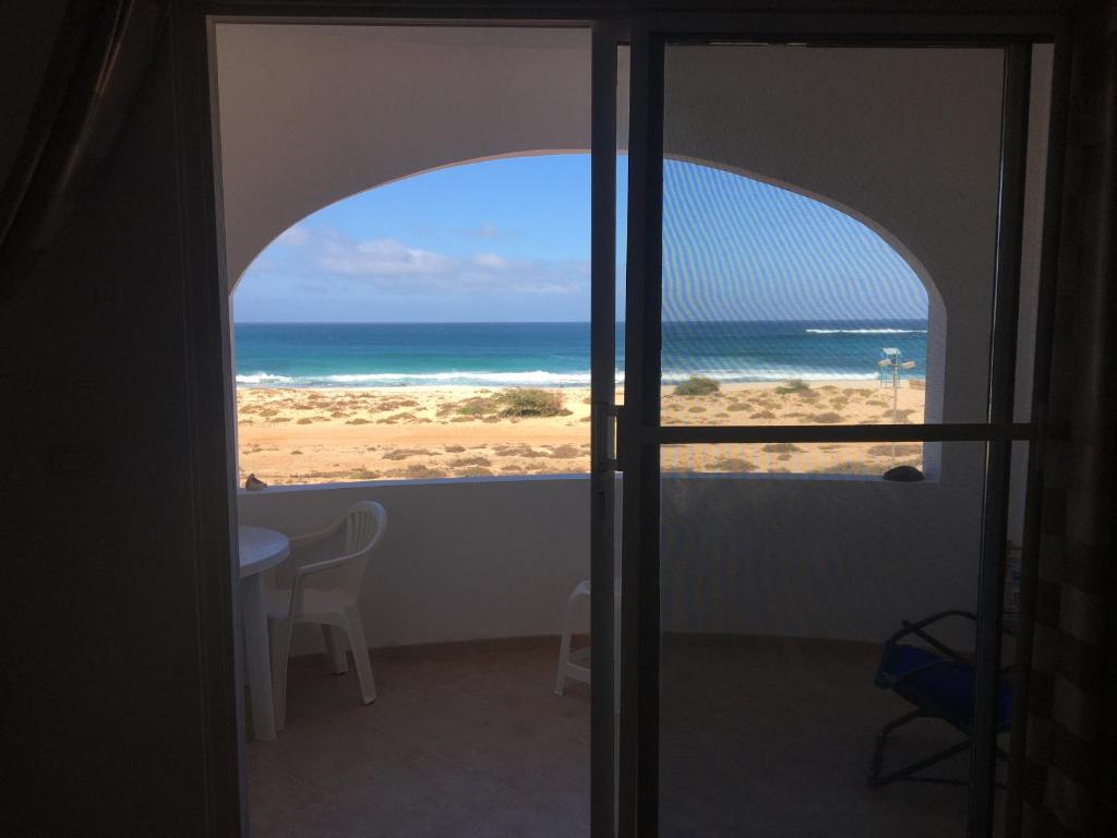 a view of the beach from a room with an open door at Pandora Ocean View am Praia Cabral in Sal Rei