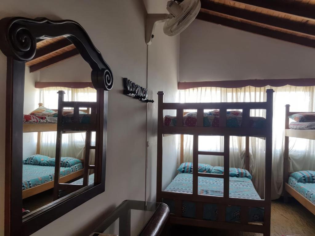 a room with two bunk beds and a mirror at Casa frente al mar hasta 15 personas in Necoclí