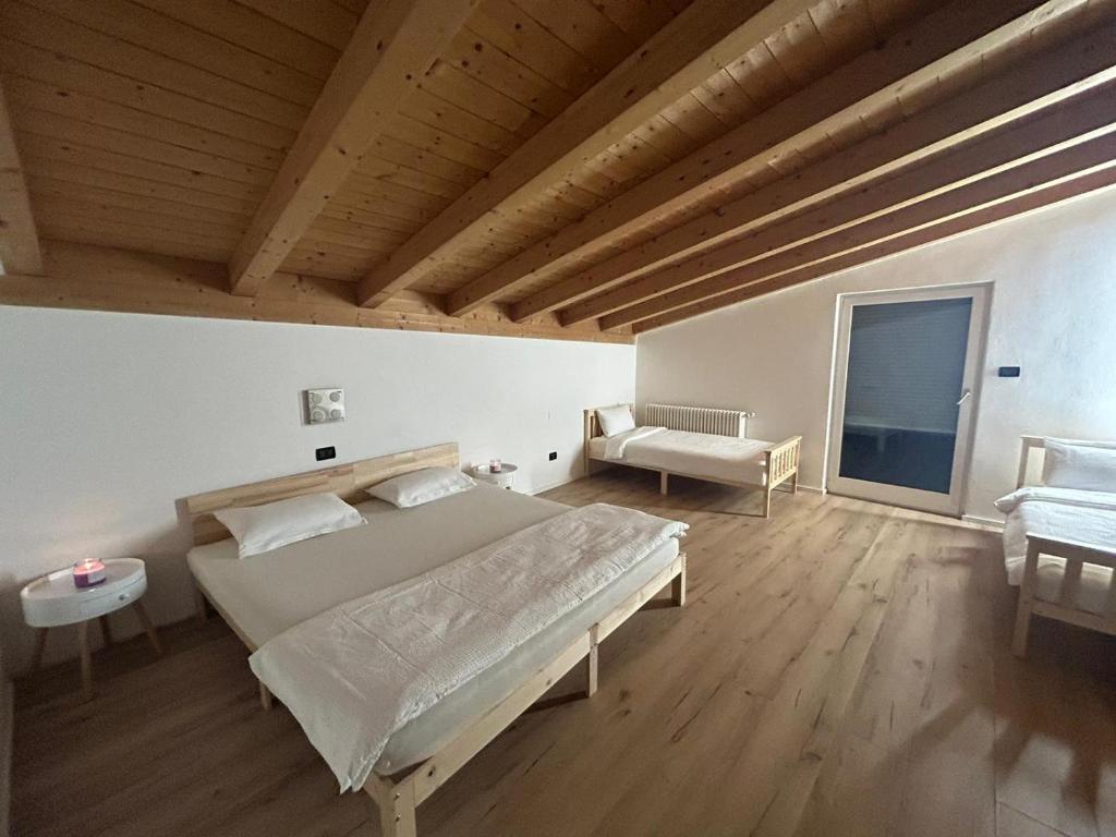 a bedroom with a large bed in a room with wooden ceilings at Adam Apartments in Merano