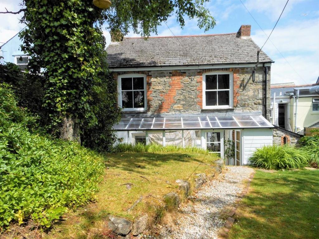 an old stone house with a solar roof at Lovely cottage with private garden in Penryn