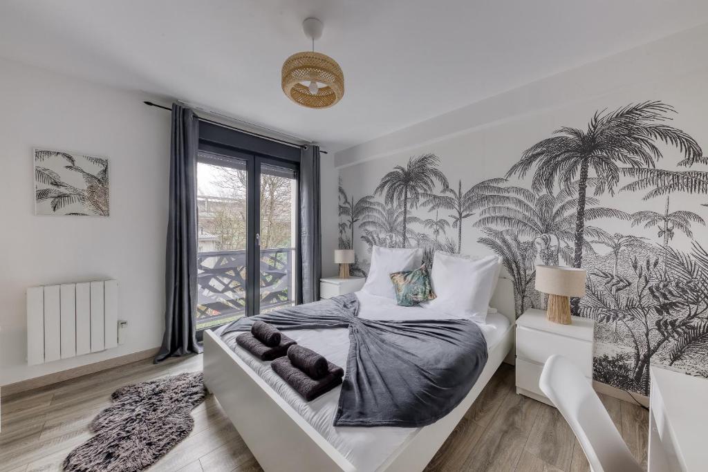 a bedroom with a bed with palm trees on the wall at Central 3 - 10 min Paris - 30 min Disney - Free Parking - 5 min RER A in Fontenay-sous-Bois