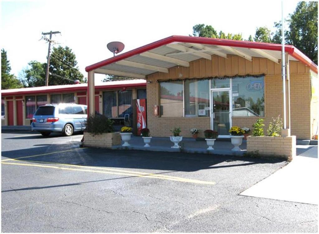 een tankstation met een auto op een parkeerplaats bij Royal Inn Linden in Linden