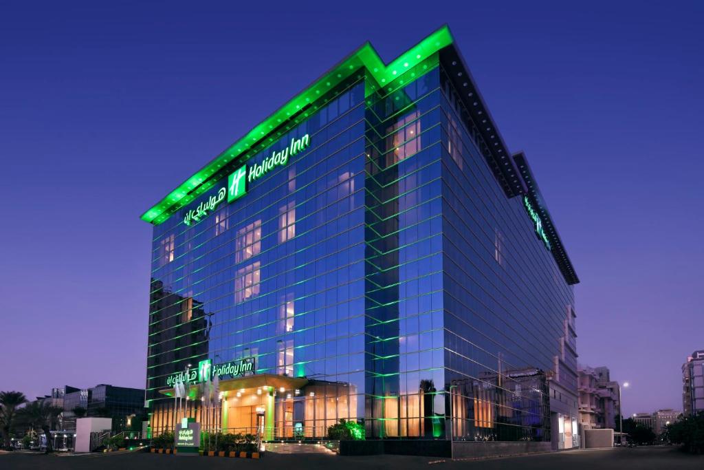 a building with a green sign on top of it at Holiday Inn Jeddah Corniche, an IHG Hotel in Jeddah