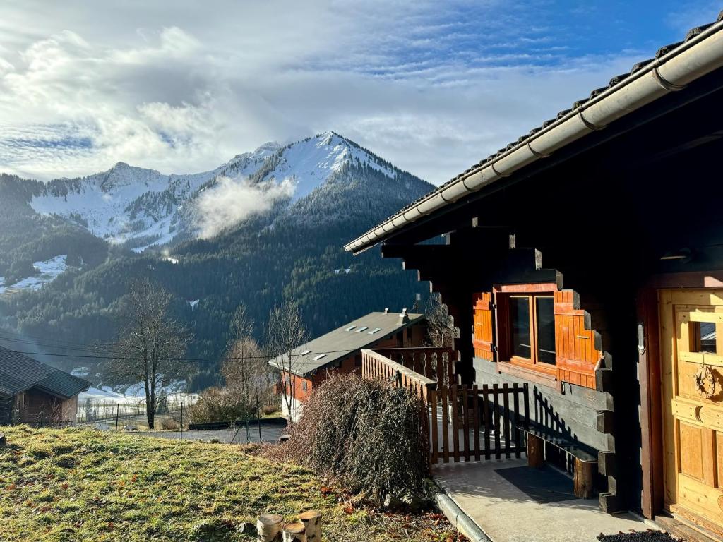 a house with a view of a mountain at Charming, cosy chalet nestled in a breathtaking surrounding with spectacular, stunning mountain views in La Chapelle-dʼAbondance