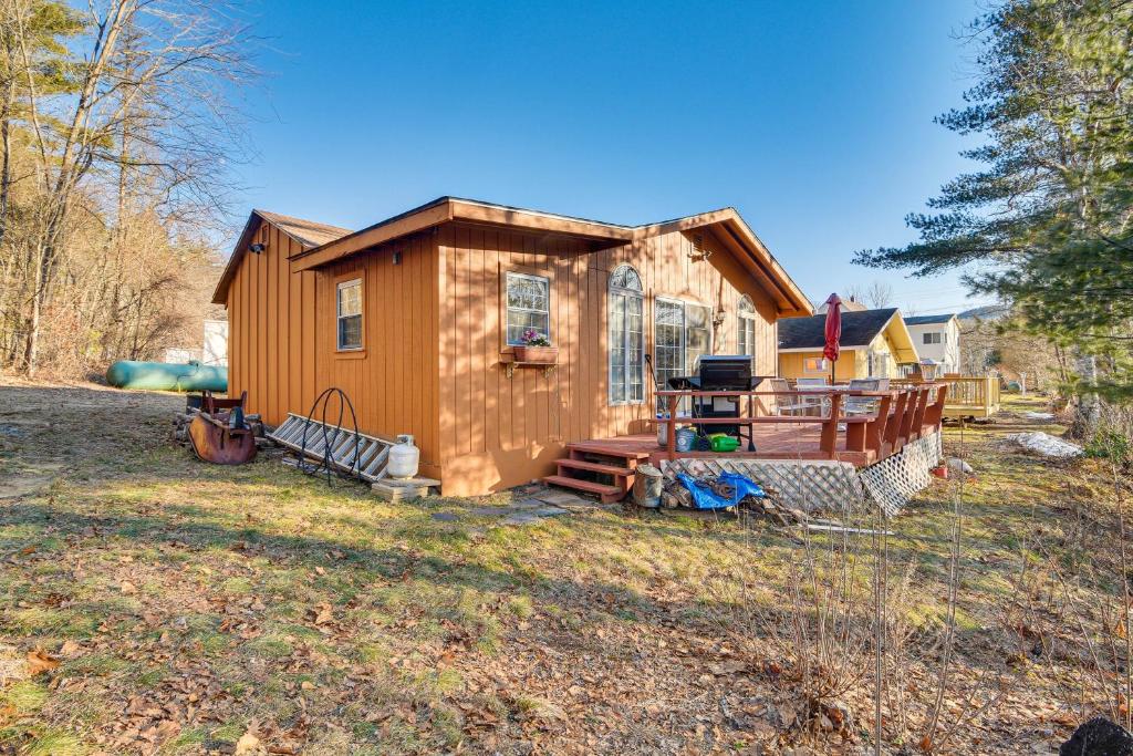 a tiny house with a porch and a yard at Glen Cottage with Deck and River View 3 Mi to Skiing! in Glen