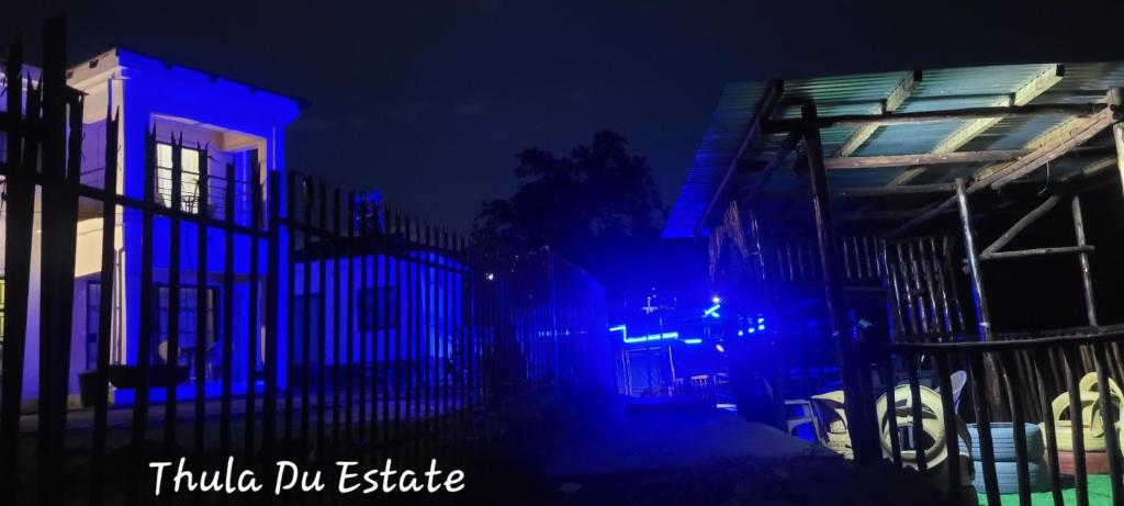 a building with blue lights on it at night at Thula Du Estate - family houses in Mbabane