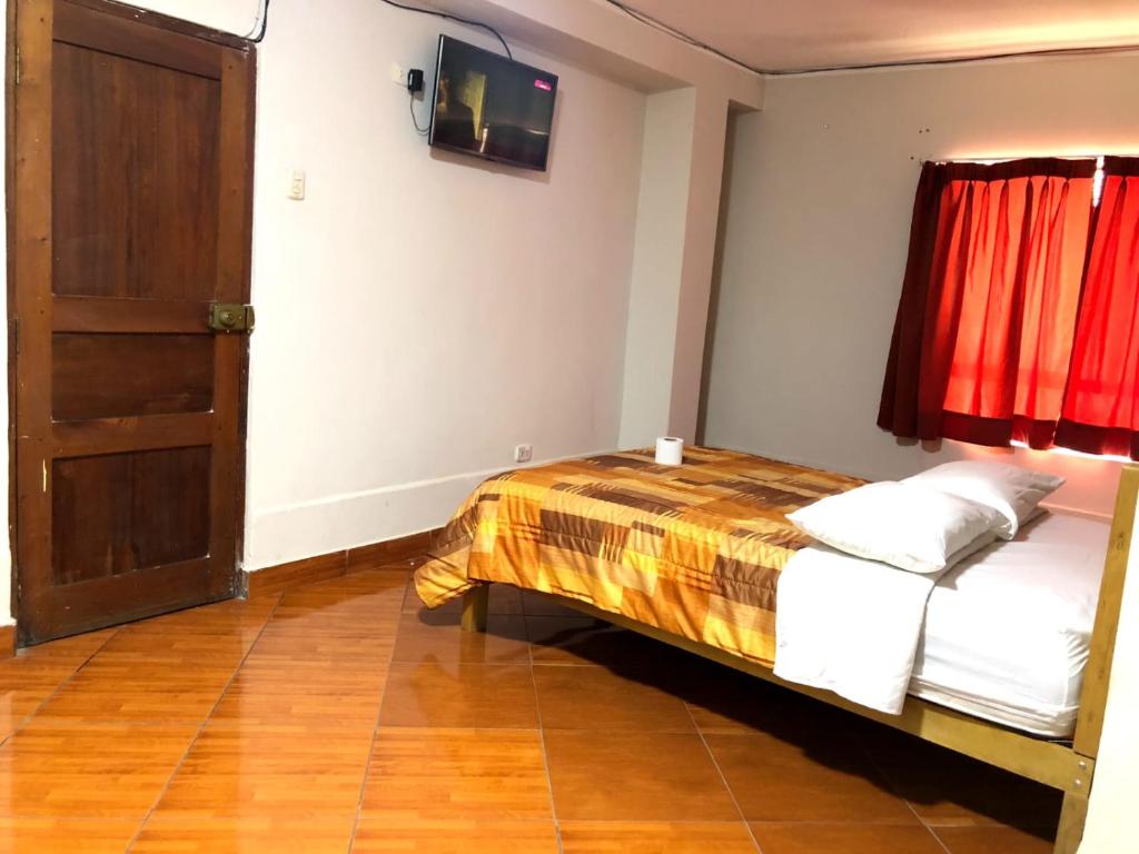 - une chambre avec un lit et du parquet dans l'établissement Hotel Los Chankas, à Ayacucho