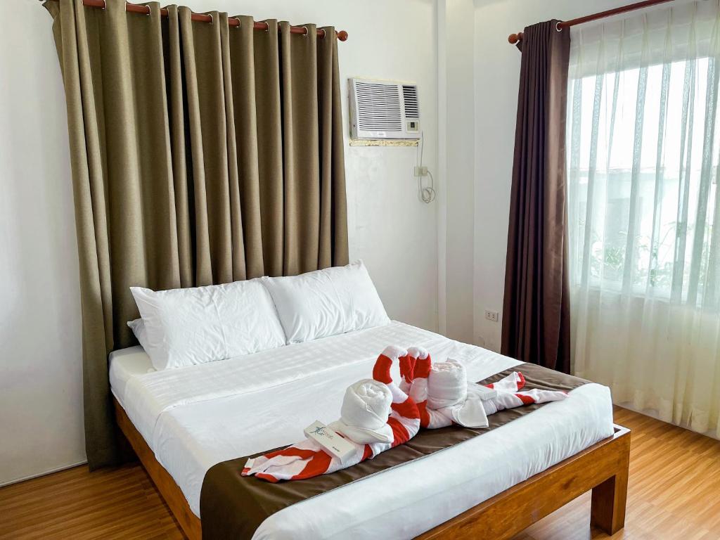 Postel nebo postele na pokoji v ubytování Funtasea Hotel and Beach Resort