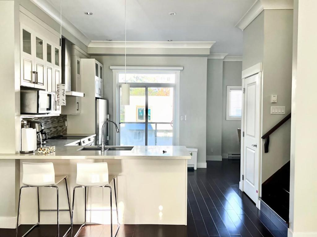 a kitchen with a counter and two stools at Spacious Home in Richmond in Richmond