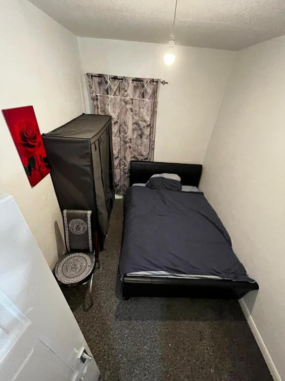 a small bedroom with a bed and a television at 28 Vicarage Street in Failsworth