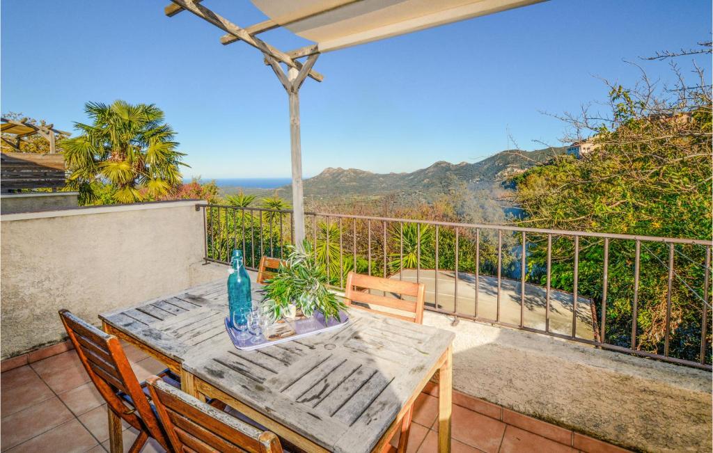 a table and chairs on a balcony with a view of the ocean at Lovely Apartment In Costa With Outdoor Swimming Pool in Costa