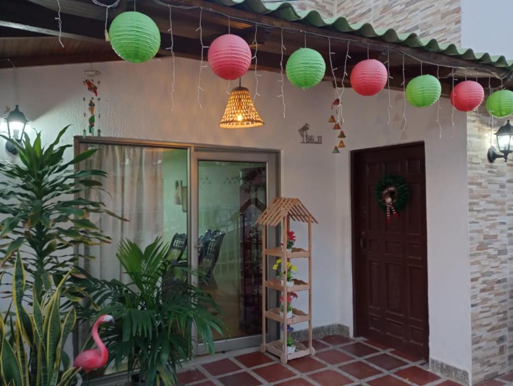 Hospedaje Casa Pachi en Cartagena de Indias في كارتاهينا دي اندياس: منزل به مصابيح وردية وأخضر معلقة من السقف