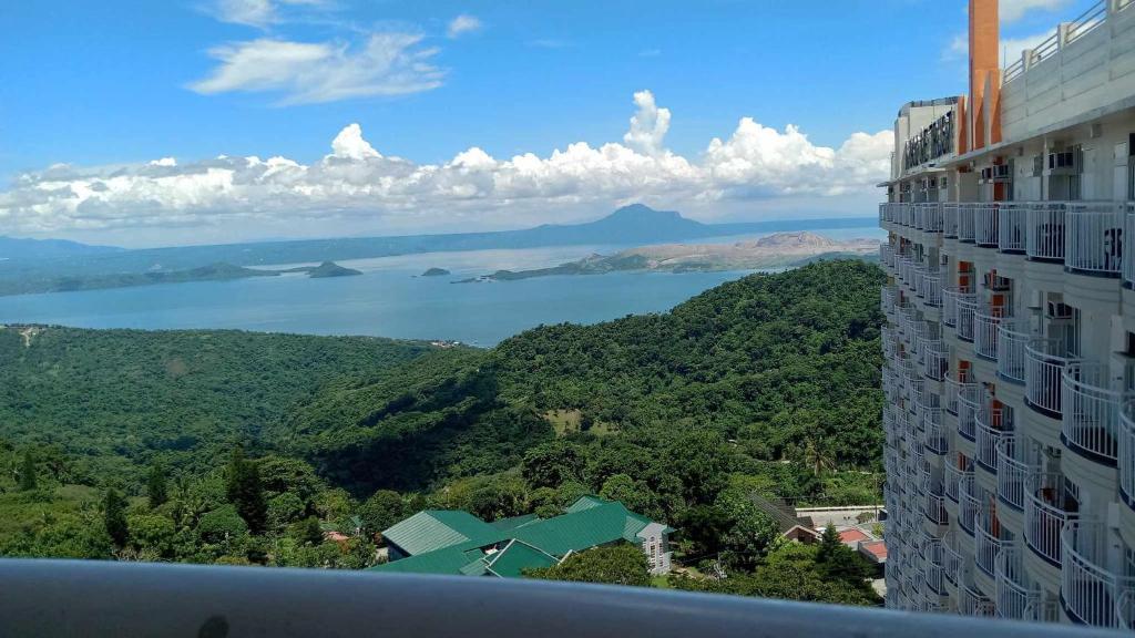 a view of a building with a view of a lake at City Land Prime Residences Tagaytay in Tagaytay