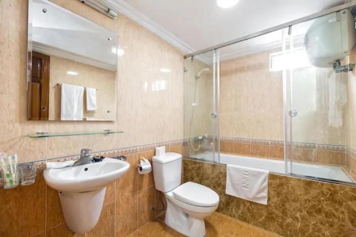 a bathroom with a toilet and a sink and a shower at Old Quarter Autumn To Tich Ha Noi in Hanoi