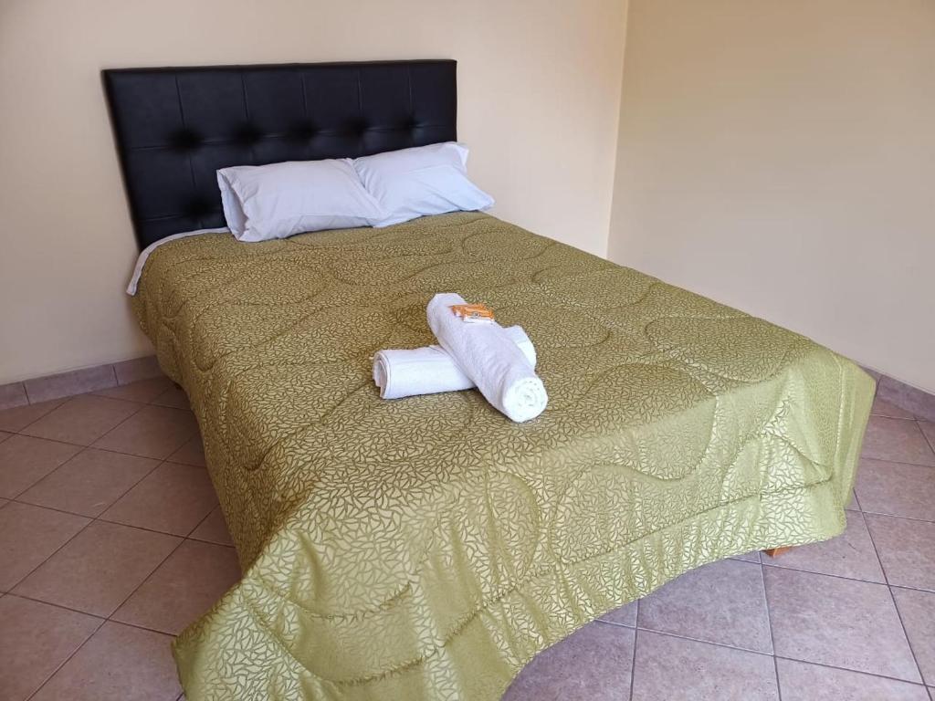 two towels sitting on top of a bed at HOSPEDAJE DONA in Ayacucho