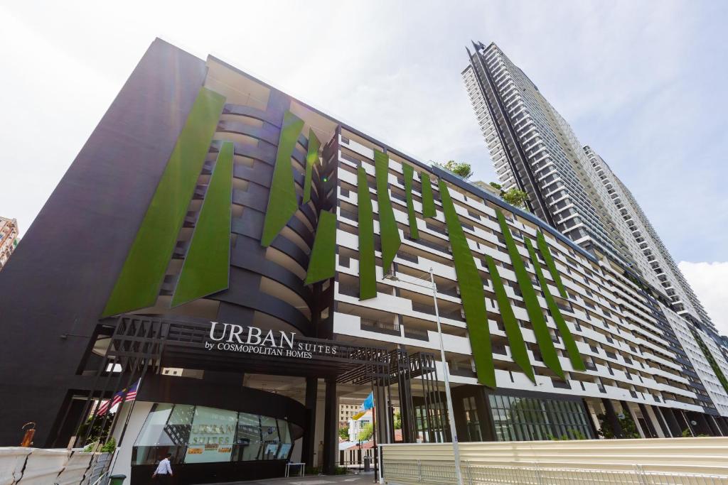 a building in front of a tall skyscraper at Urban Suites in Jelutong