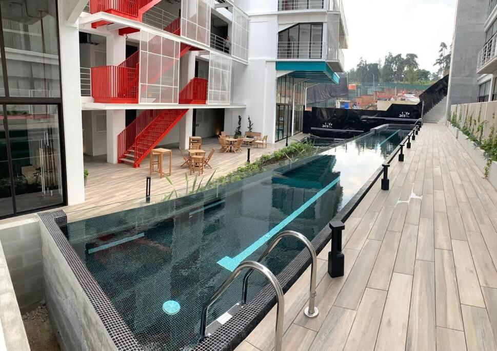 a swimming pool on the side of a building at Modern Apartment near Cayala in Guatemala