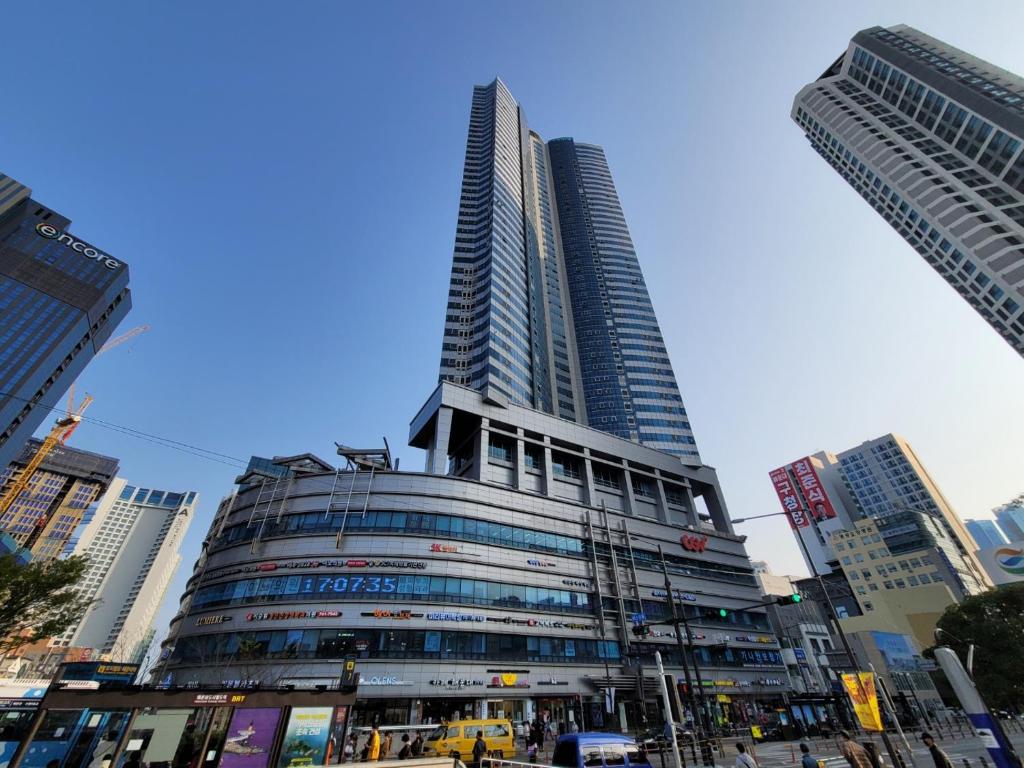 a tall building in the middle of a city at W Residence Hotel in Busan