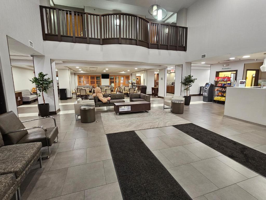 a living room with couches and chairs and a lobby at Wingate by Wyndham - Dulles International in Chantilly