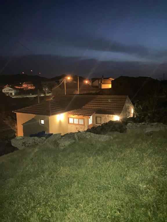 a house with lights on top of it at night at BezerreiraComVida-O refúgio do monte in Bezerreira