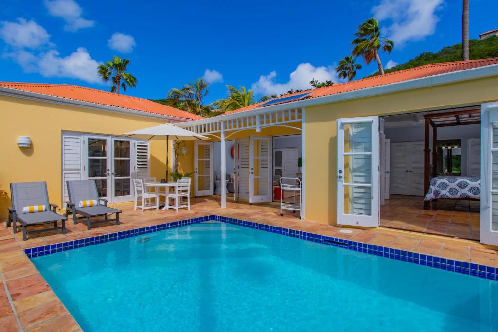 a villa with a swimming pool and a house at Seaview Palms Villa - St Croix USVI in Christiansted
